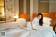 A woman laying on a bed in a hotel room.