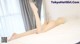 a naked woman laying on top of a bed