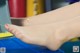 A close up of a woman's foot on a blue chair.