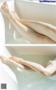 A woman's legs in a bathtub with water on them.